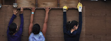 three designbuild students lift wood on a construction training project in oaxaca, mexico